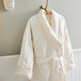 close up shot of scandia home down robe in the color ivory